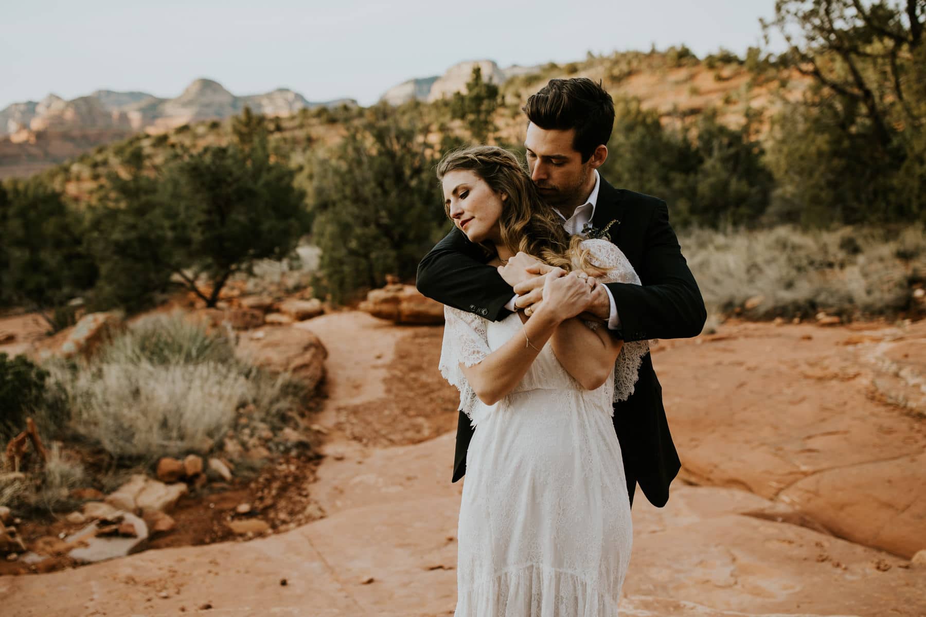 bride and groom embrace in sedona